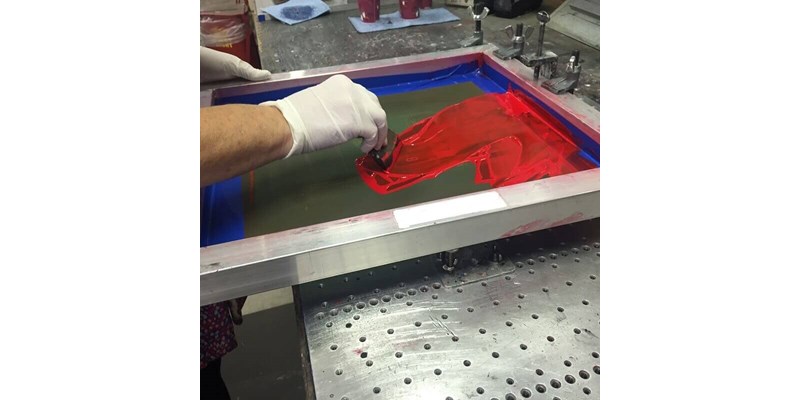ESF technician silk screening a product